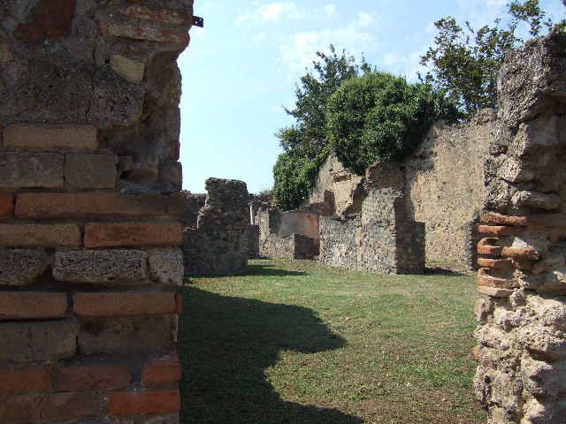 Drain? or bench outside house? on wall between VI.5.20 and VI.5.21 (back wall of VI.5.7), Pompeii.