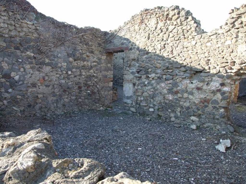 VI.7.15 Pompeii. December 2007. Looking north over wall into large room or triclinium on south side of yard. Photo taken from VI.7.14.
