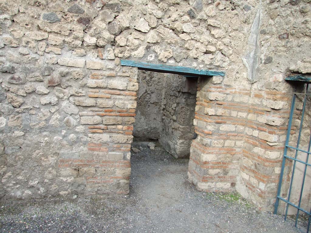 VI.8.9 Pompeii. December 2007.
North-east corner of large rear room, with open doorway to small room at rear. The barred gate is the doorway to VI.8.13.