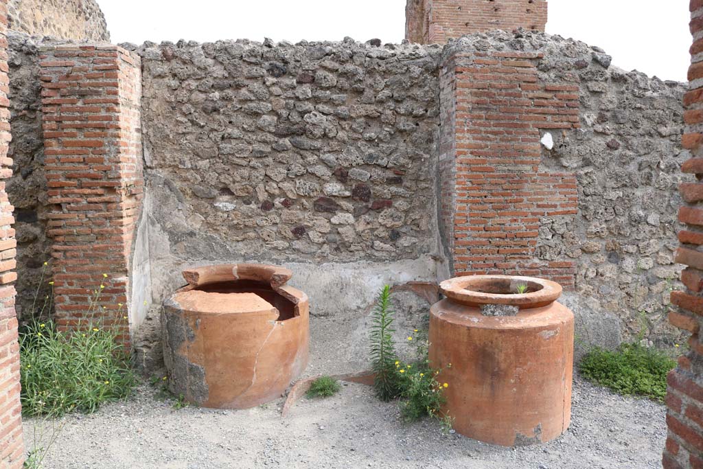 VI.8.9 Pompeii. December 2018.
Remains of four dolia against the east wall in the north-east corner of the thermopolium. Photo courtesy of Aude Durand.