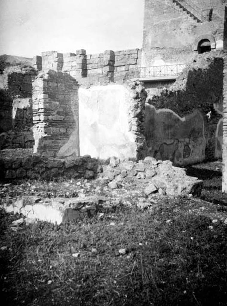 6.9.1 Pompeii. W660. Looking north-west across the walkway (room 4) on north side of garden 18. On the right, through the open doorway, are the remains of the west wall of room 11, the large oecus.
Photo by Tatiana Warscher. With kind permission of DAI Rome, whose copyright it remains. 
See http://arachne.uni-koeln.de/item/marbilderbestand/231236 
According to Warscher, this photograph showed the north-west corner of the Xystus where one could see the remains of a podium, the channel, and the mouth of the cistern.
In the background was the triclinium �L�.
See Warscher, T, 1938: Codex Topographicus Pompejanus, Regio VI, insula 9: Pars prima, (no.23), DAIR, Rome.  
