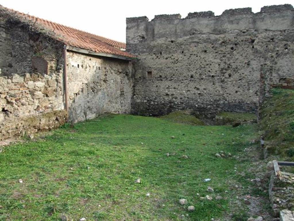 VI.9.1 Pompeii. December 2007. Looking south.
According to Jashemski, this area was the site of the spacious L-shaped garden of the Hospitium, room 18. It was excavated in 1830. On the west side of the garden was an exceptionally large triclinium, room 15, with windows onto the garden area. Remains of the wall with windows can be seen on the right of the photo.
See Jashemski, W. F., 1993. The Gardens of Pompeii, Volume II: Appendices. New York: Caratzas. (p.137)
According to Warscher, quoting Minervini in Bull. Napol. 1843, p.69, she described  �
�The open space of which we have already spoken, and to which one exits from the last described cubiculum, was perhaps used as a garden,  and onto which opened three large windows, one of which was from the already described cubiculum, and two were in the walls of the big room, (the large triclinium) as we have said, to the right of the atrium.  A masonry channel collected water that fell from the roof and carried it into a cistern, of which one could see the double mouth. Also in the wall in front of this garden were more windows intended to give light to a workshop at the back of the garden, of this same, we must investigate further.  Behind the already described channel was a spacious room in which we could see other cistern openings, however with whitewashed masonry and a black zoccolo. This room certainly supported the roof slope towards that channel: this room communicated with the atrium, and also had a doorway, which now could be seen walled up, with another room ... ...�
See Warscher, T, 1938: Codex Topographicus Pompejanus, Regio VI, insula 9: Pars prima, (see photographs nos: 21, 22 and 23), Rome, DAIR, whose copyright they remain.  
