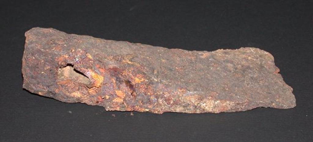 VI.9.1 Iron axe head, front view.  Height 0.033m, width 0.057m, length 0.14m.  OA 2811 Hache, mus�e Cond�, photo RMN � R.G. Ojeda