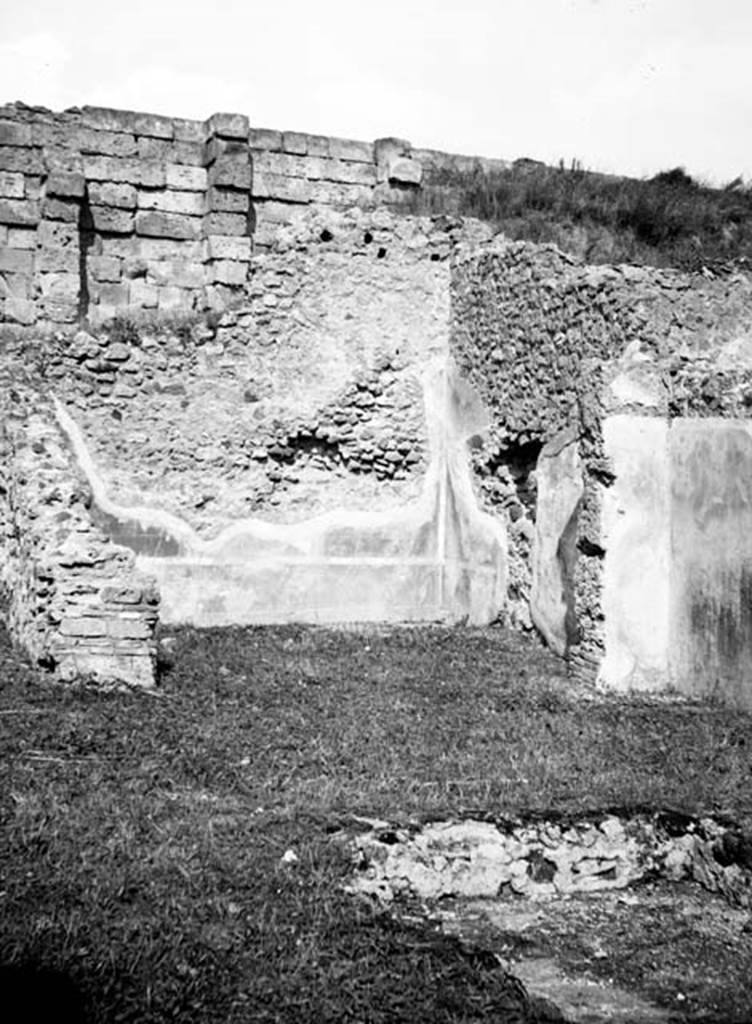 231233 Bestand-D-DAI-ROM-W.653.jpg
6.9.1 Pompeii. W653. Looking north across and impluvium towards oecus, room 12.
Photo by Tatiana Warscher. With kind permission of DAI Rome, whose copyright it remains.
See http://arachne.uni-koeln.de/item/marbilderbestand/231233
According to Packer, the impluvium had been described as a rectangular basin with the short sides on the north and south sides. Originally it would have had a white marble rim. At the time of his writing in 1978, he stated that it had disappeared. Room12 would have had a red dado embellished with painted plants, above which was a deep red zone separated by yellow areas and arabesques.
See Cronache Pompeiane, IV, 1978, for article by Packer, J: Inns at Pompeii: a short survey (p.24-30)
See Bullettino Archeologico Napolitano, 1,1843, p.69