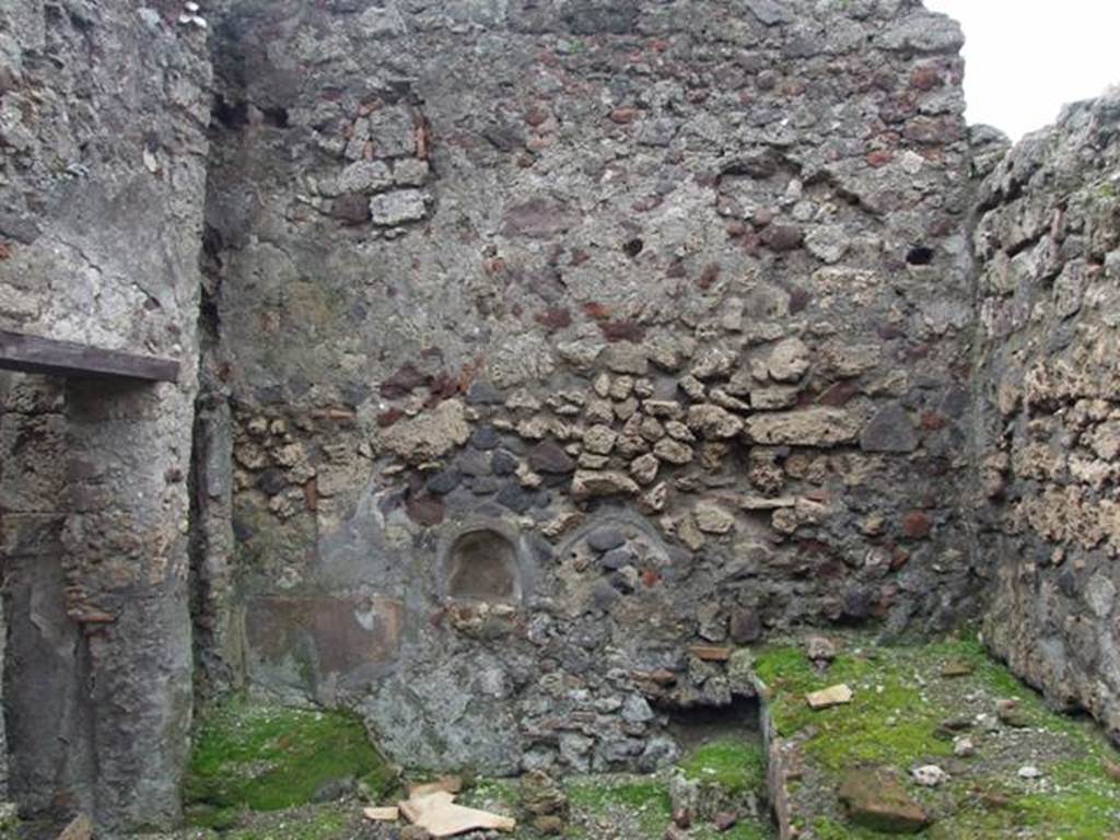 VI.9.6 Pompeii. March 2009. Room 18, west wall with small arched niche, in kitchen and latrine. According to Boyce, a fragmentary painting of Fortuna holding a rudder upon a globe, and below her, the two serpents and an altar, was reported to have been found in the kitchen. No trace of the painting exists now. See Boyce G. K., 1937. Corpus of the Lararia of Pompeii. Rome: MAAR 14. (p.50, 177B).