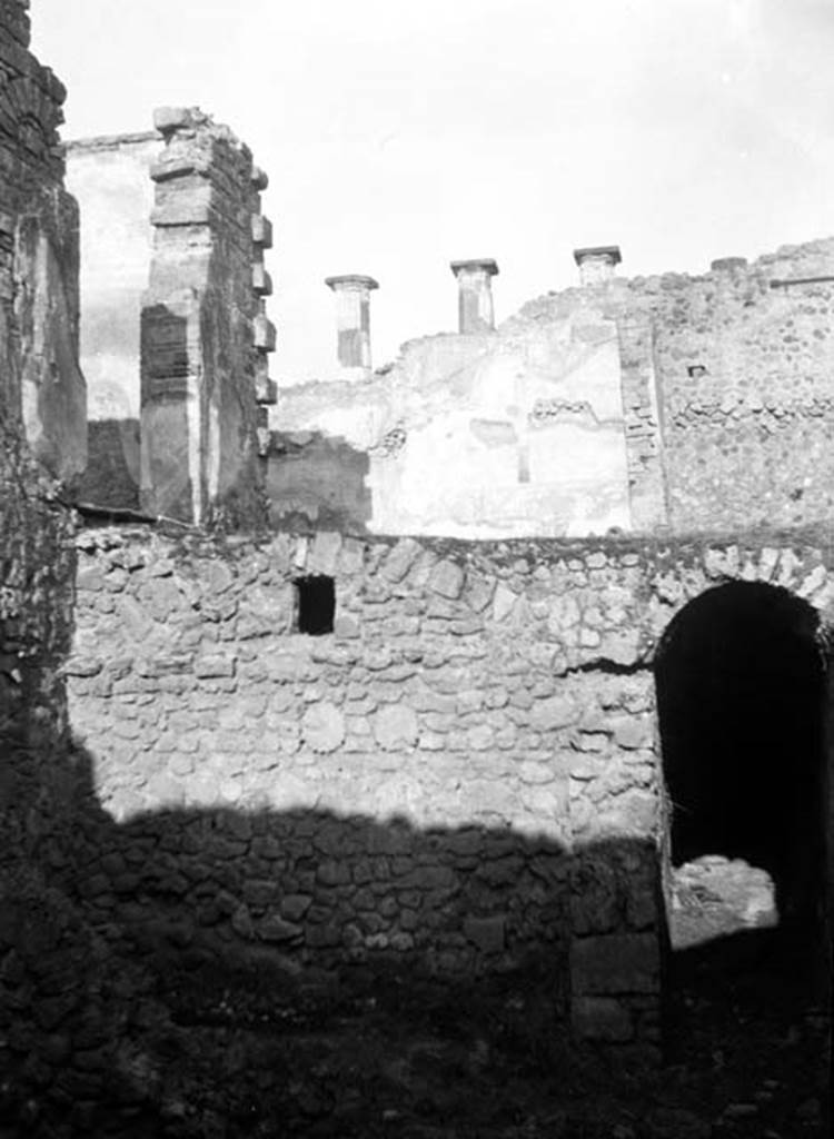 230881 Bestand-D-DAI-ROM-W.729.jpg
6.9.10 Pompeii. W729.  Looking north towards entrance to corridor and underground kitchen, on lower level. On the left of the upper level are the doorways from the tablinum 26 and triclinium 27 onto the portico and peristyle at 29/30. Taken from rear of 6.9.5.
Photo by Tatiana Warscher. With kind permission of DAI Rome, whose copyright it remains. 
See http://arachne.uni-koeln.de/item/marbilderbestand/230881  
