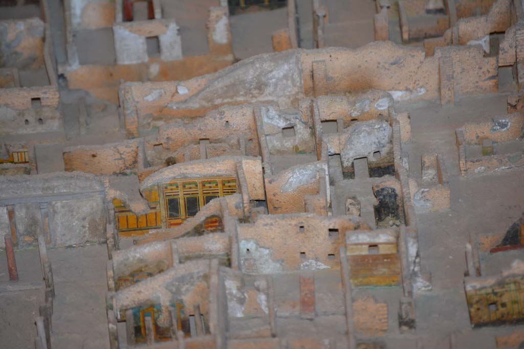 VI.11.9/10 Pompeii. July 2017. Looking west towards rooms at north end of peristyle 36.
On the left in the centre, the painted yellow/black wall of room 39 can be seen.
At the rear of it, on the right, the room 18.
On the right in the centre, the black painted walls, would appear to below to VI.11.8, and would mark the north boundary of this combined house. 
From cork model in Naples Archaeological Museum.
Foto Annette Haug, ERC Grant 681269 D�COR

