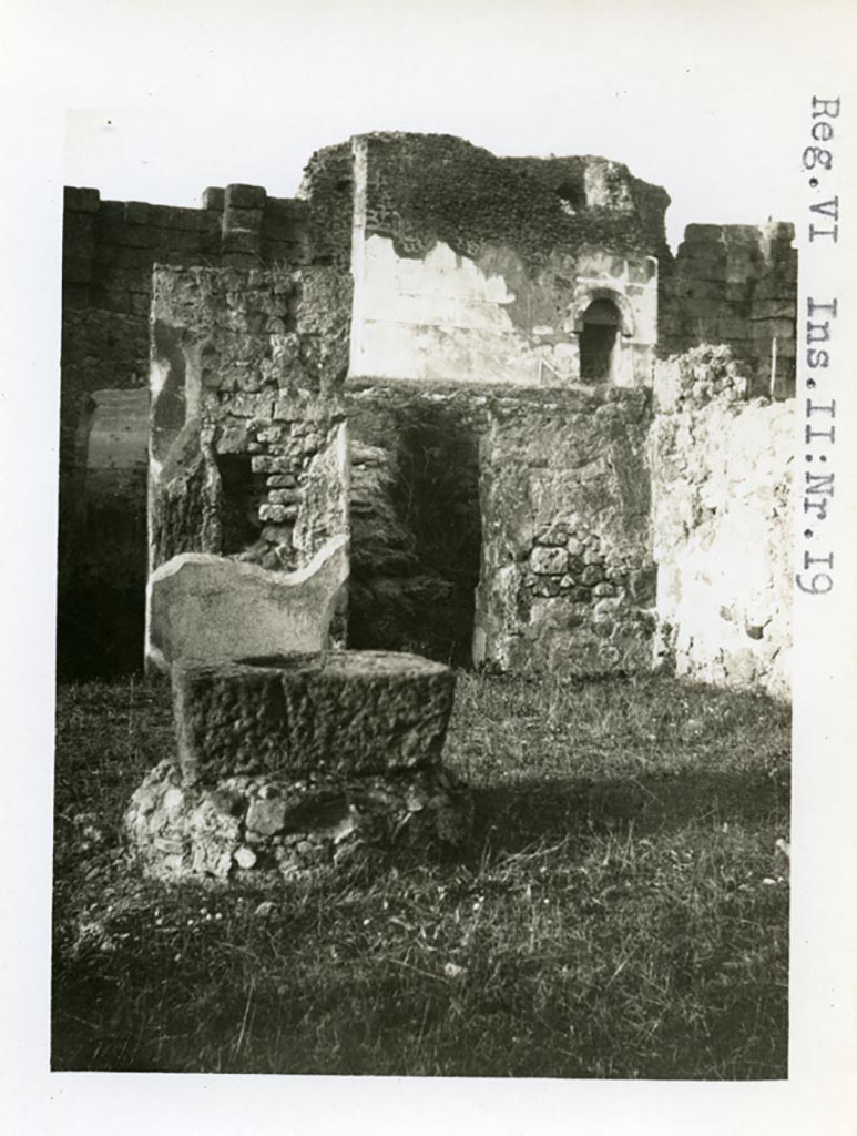 VI.1.19 Pompeii. Pre-1937-39.
Looking north-east across atrium towards room with stairs to upper floor and doorway from VI.11.20.
Tower X can be seen in the background.
Photo courtesy of American Academy in Rome, Photographic Archive. Warsher collection no. 028.
