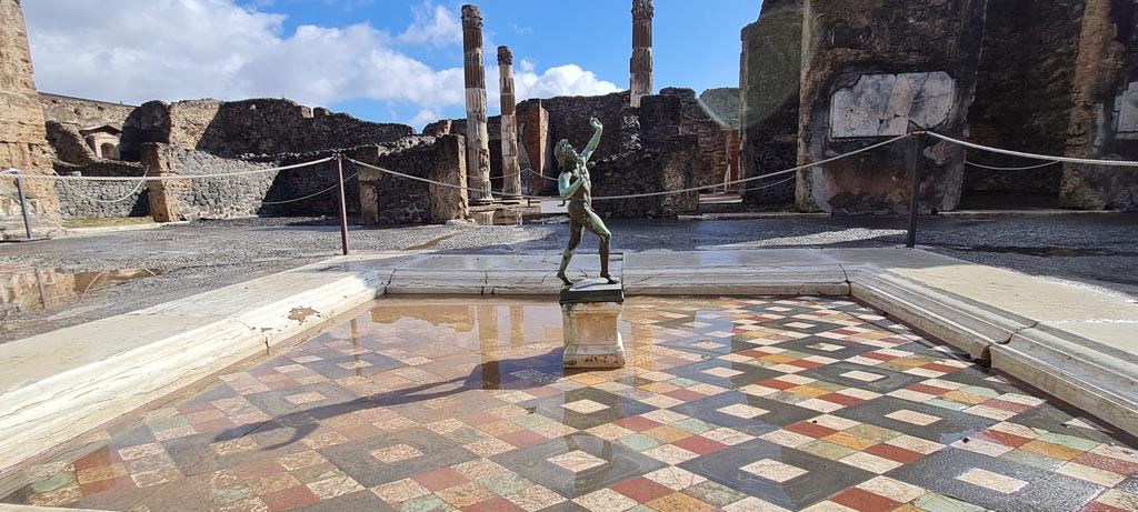 VI.12.2 Pompeii. April 2022. 
Looking across impluvium in atrium towards east side, and through to atrium of VI.12.5. Photo courtesy of Giuseppe Ciaramella.

