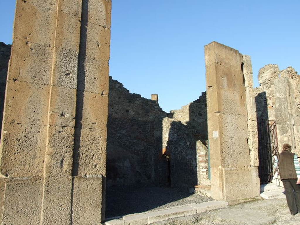 VI.12.4 Pompeii. December 2006. Entrance doorway, with the possible site of graffito below, on right between VI.12.4 and 5. According to Pagano and Prisciandaro, graffito found, painted in red, on the 3rd pilaster after entrance 2 was �
M(arcum) Holconium Priscum
C(aium) Gavium Rufum IIvir(os)
[3]ellus fecit Saturninus.    [CIL IV 297 and CIL IV 297a]
See Pagano, M. and  Prisciandaro, R., 2006. Studio sulle provenienze degli oggetti rinvenuti negli scavi borbonici del regno di Napoli.  Naples : Nicola Longobardi. (p.145)  PAH III, 116.
