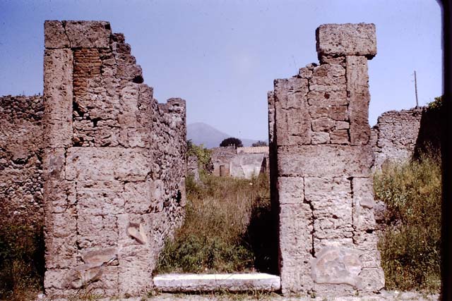 VI.13.2 Pompeii. December 2004. Atrium and impluvium. On 13th September 1943 at 17.00 hours much damage was done when two bombs landed here. 
One caused the demolition and destruction of three rooms on the west side of the atrium, with a large part of the perimeter wall onto Vicolo del Fauno. The other damaged another three rooms on the south-east side, together with the perimeter wall on the east side.  The south-west of the peristyle was also destroyed together with surrounding areas, including the lararium on the east side.
See Garcia y Garcia, L., 2006. Danni di guerra a Pompei. Rome: L’Erma di Bretschneider. (p. 85)

