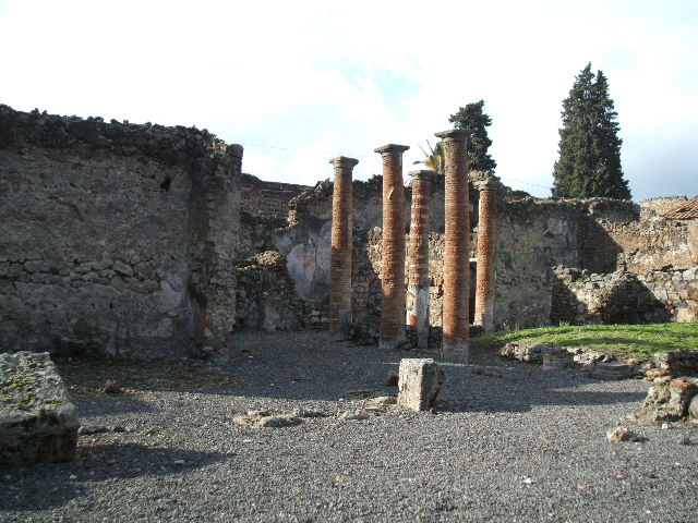 VI.13.8 Pompeii. December 2004. Looking south-west from rear entrance, towards atrium. According to Garcia y Garcia, in 1943 a bomb destroyed the rear entrance. The three nearby rooms on the south-east side of the peristyle were destroyed as well as a good part of the east wall. See Garcia y Garcia, L., 2006. Danni di guerra a Pompei. Rome: L’Erma di Bretschneider. (p.86-87)
According to Della Corte, the peristyle was transformed into a weaving workshop, probably after the earthquake of 62AD. The workers took time to scratch their names in the portico.  The names of seven men were found - Vesbius or Vesbius Tamudianus, Felix, Ephesus, Xanthus, Successus, Faustus, and Florus: The  names of eleven women were found - Vitalis, Florentina, Amaryllis, Ianuaria, Heracla, Maria, Lalage, Damalis,  ….rusa,  .a., Baptis, and Doris.  Della Corte noted that two of the names were Jewish – that of Maria, and Vesbius Tamudianus.    
See Della Corte, M., 1965.  Case ed Abitanti di Pompei. Napoli: Fausto Fiorentino. (p.121) [CIL IV (1493-1509]  
According to Epigraphik-Datenbank Clauss/Slaby (See www.manfredclauss.de), these read as –
Vesbius Tamudianus     [CIL IV 1493]
Pottttas 
X                  [CIL IV 1494]
Vesbius     [CIL IV 1495]
Quibusos  [CIL IV 1496] 
Felix           [CIL IV 1497]
Felix           [CIL IV 1498]
Nero Poppaeeses istis   [CIL IV 1499] 
Cum           [CIL IV 1500]
Vibius        [CIL IV 1501]
Mamoe      [CIL IV 1502] 
Ephesus 
Fututor      [CIL IV 1503] 
Felix           [CIL IV 1504] 
Xanthus    [CIL IV 1505]
Successus     [CIL IV 1506]
Maria pe(nsi) stamen       [CIL IV 1507] 
Nua[3] 
Procu/lus hoc                    [CIL IV 1508]
Faustus Felix F[l]oru(s)   [CIL IV 1509]


