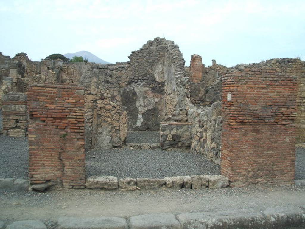 VI.14.3 Pompeii. December 2007. North wall with hearth in north-east corner and doorway to rear room.