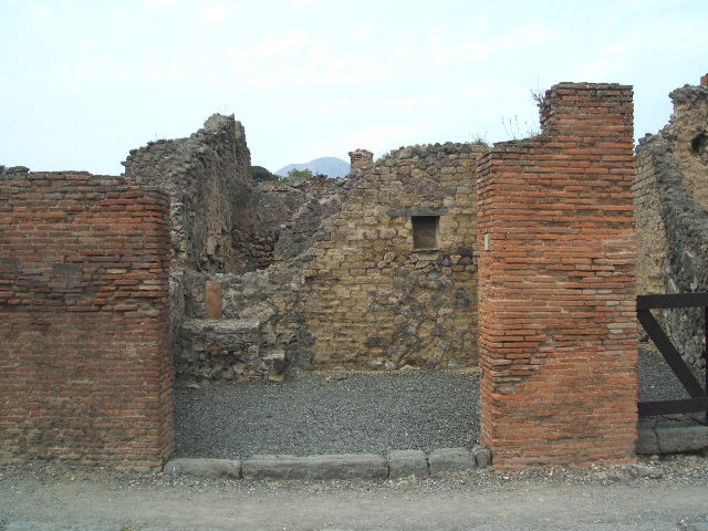 VI.14.4 Pompeii. September 2005. North wall with base of steps to upper floor in north-west corner. Behind the steps can be seen a down-pipe from the upper floor. See Boyce G. K., 1937. Corpus of the Lararia of Pompeii. Rome: MAAR 14. (p. 52, no.196)