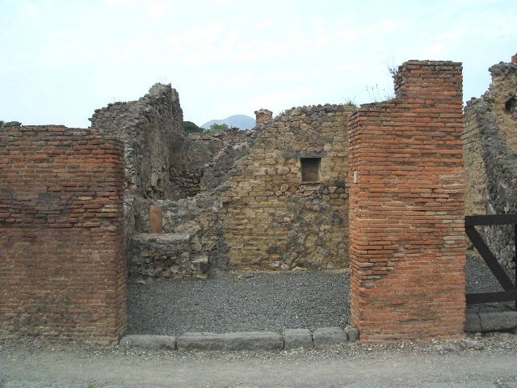 VI.14.4 Pompeii. December 2006. Masonry base of steps to upper floor, with down-pipe behind.