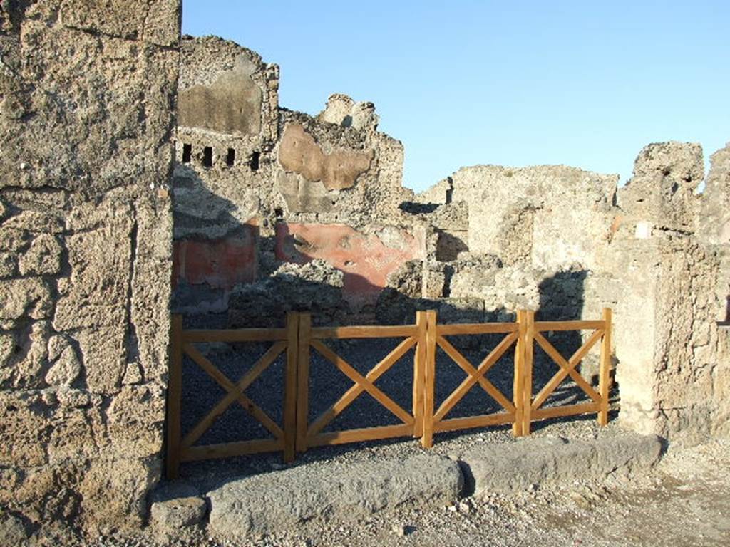 VI.14.8 Pompeii. December 2004. Doorways to two rear rooms. According to Eschebach, on the left was a triclinium, on the right was a small room with stairs to upper floor. See Eschebach, L., 1993. Gebäudeverzeichnis und Stadtplan der antiken Stadt Pompeji. Köln: Böhlau. (p.209)