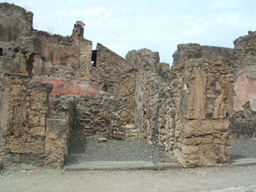 VI.14.9 Pompeii. December 2006. North wall with doorway to light-yard.
