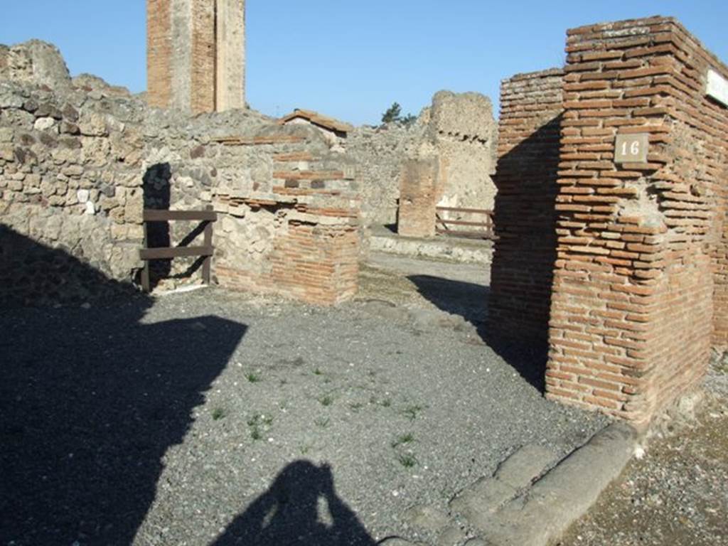 VI.14.16 Pompeii, entrance doorway on Via della Fortuna, on the left, with VI.14.17 doorway on Via del Vesuvio in background. December 2007. According to Della Corte, on the front of the street, a recommendation was found towards the south-east corner of insula VI.14. He could not say exactly where it was found, but it was written by a society of tavern-keepers in support of the candidate Sallustius Capito. It read - Caupones facite    [CIL IV 336]
See Della Corte, M., 1965.  Case ed Abitanti di Pompei. Napoli: Fausto Fiorentino. (p.121)
According to Epigraphik-Datenbank Clauss/Slaby (See www.manfredclauss.de), it read �
Sallustium Capitonem aed(ilem)
o(ro) v(os) f(aciatis) caupones facite       [CIL IV 336]
On the extreme right of the photo, at the end of the brick pilaster, another entrance can be seen. This was the entrance at the south end of the portico on the west side of Via del Vesuvio, and as such was numbered as Strada della Fortuna 28. 
