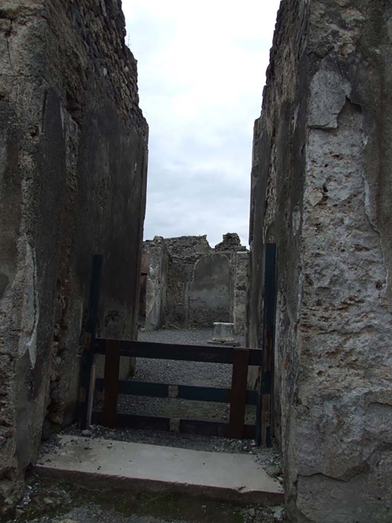 VI.14.34 Pompeii. December 2007. Garden-yard in south-east corner.   
Looking north through doorway from garden-yard towards oven in bakery.
