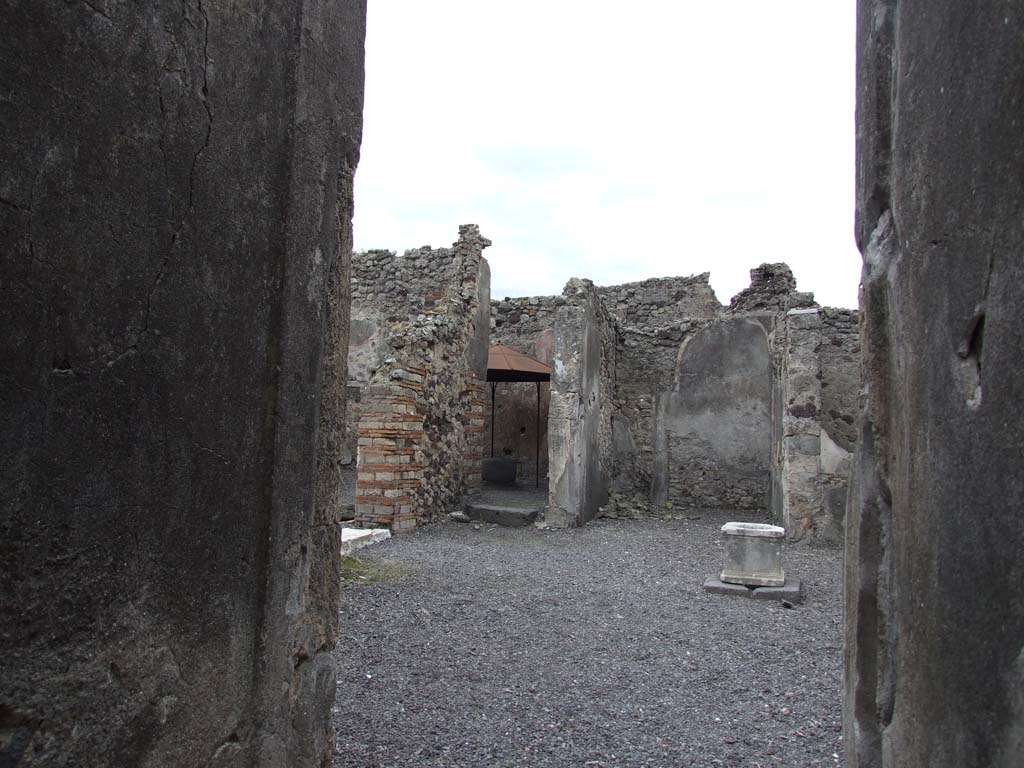 VI.14.34 Pompeii. December 2007.
Looking south-east across atrium towards entrance to bakery with white threshold, doorway to garden-yard and doorway to tablinum, from entrance corridor.
