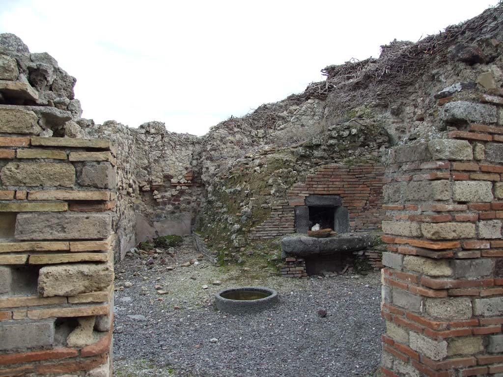 VI.14.34 Pompeii. December 2007. Looking east from atrium towards the oven in the bakery.
At the rear of the wall on the right of this entrance doorway, would be the west wall facing the oven.
According to Boyce, on the west wall facing the oven, above a low table, was a red panel in which two serpents were represented in stucco relief.
See Notizie degli Scavi di Antichità, 1876, p. 195; Bull. Inst., 1878, 196.
See Boyce G. K., 1937. Corpus of the Lararia of Pompeii. Rome: MAAR 14. (p.53, no.204, with Pl. 28,4).