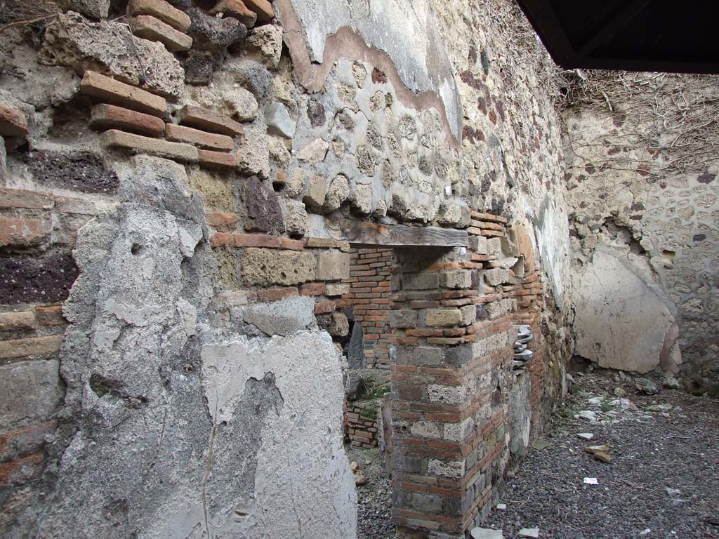 VI.14.34 Pompeii. December 2007.
Garden-yard in south-east corner. Looking north through doorway from garden-yard towards oven in bakery.