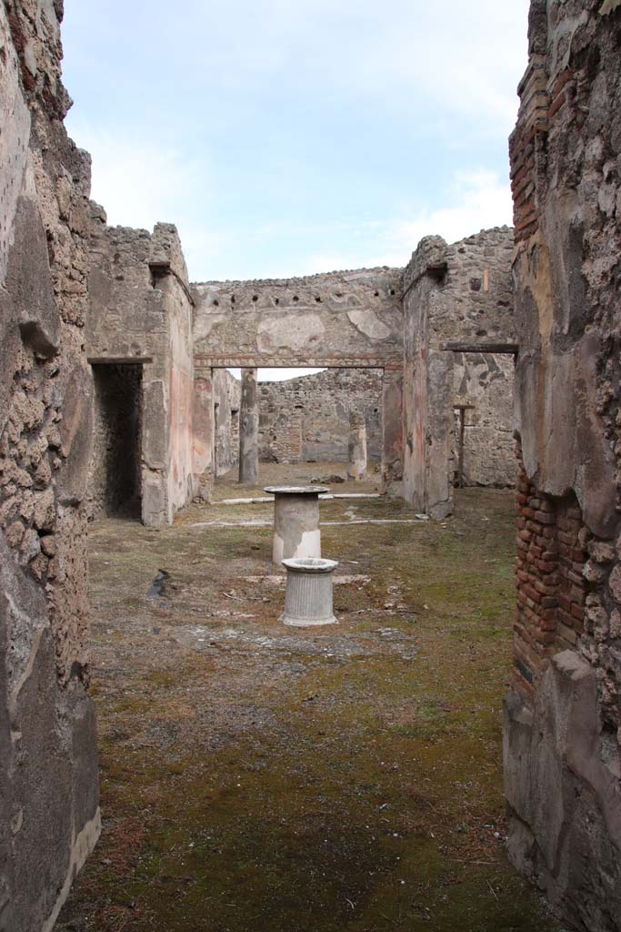 VI.14.40 Pompeii. December 2004. North wall of atrium, with doorway in north-east corner to corridor to rear.