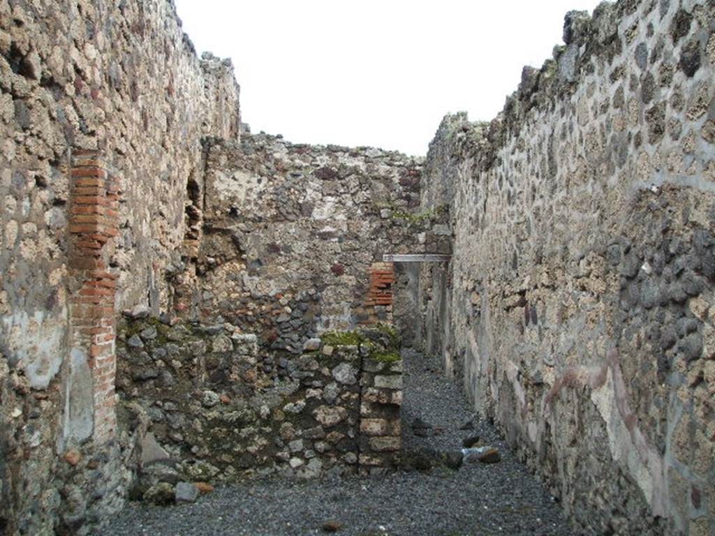 VI.14.41 Pompeii. December 2004. Looking east across workshop towards corridor to rear, on the right. On the left are two rooms. At the rear of the corridor, the doorway leads into a room with steps to the upper floor, and a doorway into the kitchen of VI.14.42. See Eschebach, L., 1993. Geb�udeverzeichnis und Stadtplan der antiken Stadt Pompeji. K�ln: B�hlau. (p.217)
