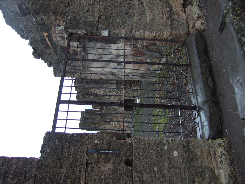 VI.14.43 Pompeii. December 2007. Room 1, looking west across atrium, towards front entrance. According to Breton, found on the left of the atrium on a pilaster that separated two cubicula, was CIL IV 1520. This would be on the right of this photo. Also found were CIL IV 1512 and CIL IV 1517
According to Epigraphik-Datenbank Clauss/Slaby (See www.manfredclauss.de), these read –
Candida me docuit nigras 
odisse puellas odero si potero sed non invitus 
amabo 
scipsit(!) Venus fisica Pompeiana      [CIL IV 1520]
Nolanis feliciter      [CIL IV 1512]
Hic [ego] nunc futue formosam 
fo[rt]e puellam morbus 
qu[3]e[3]lis form[o]sam fa
cie[m 3]VTI[3]CONEI[3]IP 
nom[3] Iul NI[3]T[3] 
NV[3]TUR Tuttu sodales hic ad exemplar 
felat n(os)t(ras) Stabianas paellas      [CIL IV 1517]
According to Cooley, CIL IV 1520 translated as – Blondie has taught me to hate dark girls. I shall hate them, if I can, but I wouldn’t mind loving them. Pompeian Venus Fisica wrote this.       [CIL IV 1520]
According to Varone, this was detached from the wall and sent to Naples Archaeological Museum, it translated as – “A fair girl taught me to scorn dark ones, I will scorn them if I can: if not…. I will reluctantly love them”   [CIL IV 1520] This was the same couplet, but with a different division of lines, that was also found under an image of Priapus, on the left of the doorway at I.11.11. [CIL IV 9847 painted in red] See Varone, A., 2002. Erotica Pompeiana: Love Inscriptions on the Walls of Pompeii, Rome: L’erma di Bretschneider. (p.56-57)

