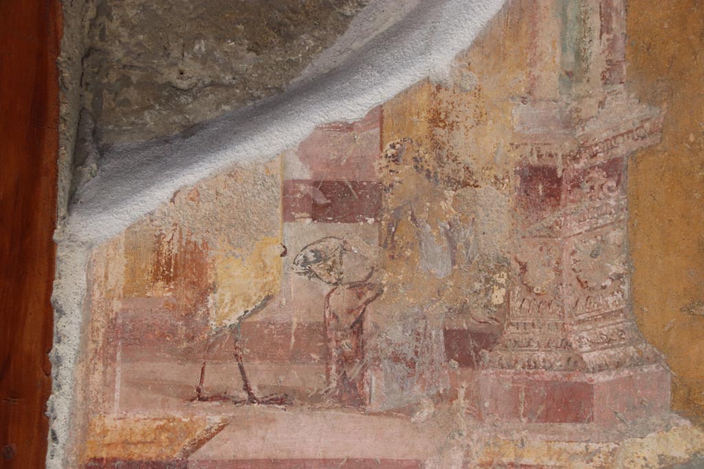 VI.15.1 Pompeii. October 2023.
Detail from north wall of atrium, painted decoration from west side of masonry base for strongbox.
Photo courtesy of Klaus Heese.