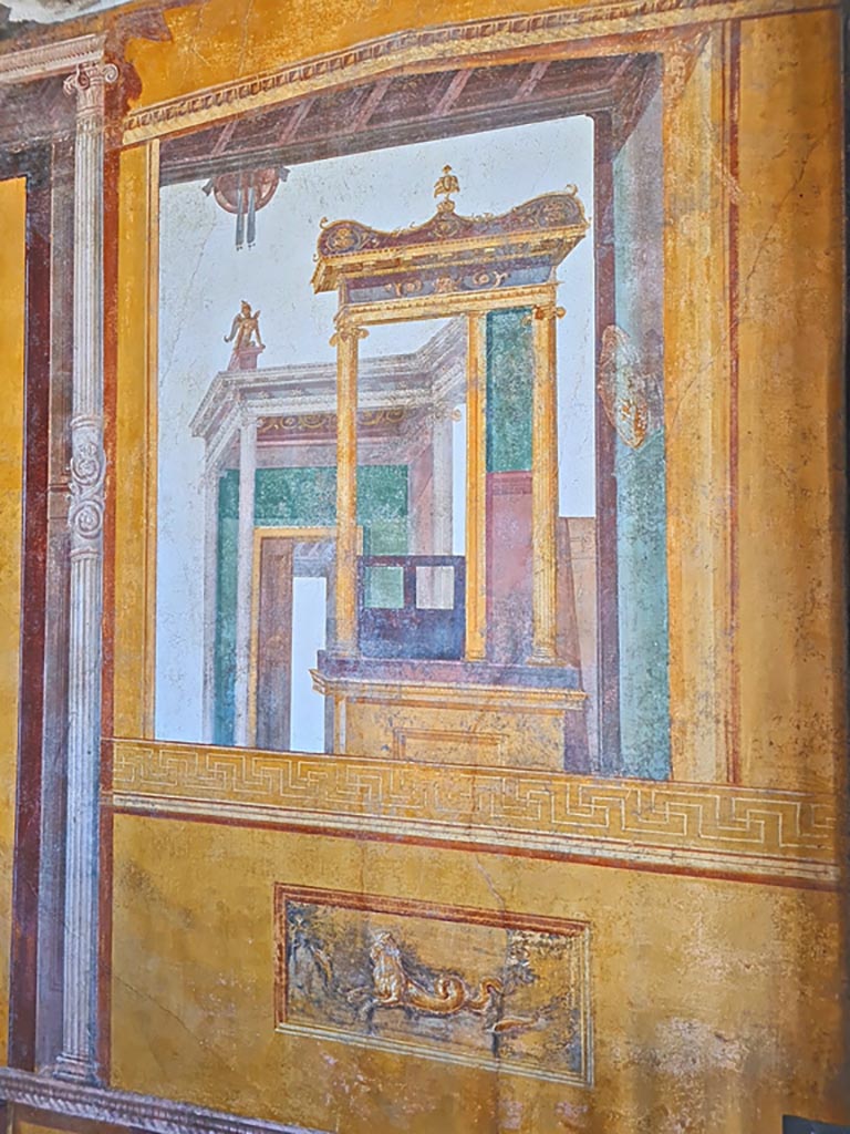 VI.15.1 Pompeii. April 2023.
Architectural wall painting on south wall in south-west corner of exedra. Photo courtesy of Giuseppe Ciaramella.