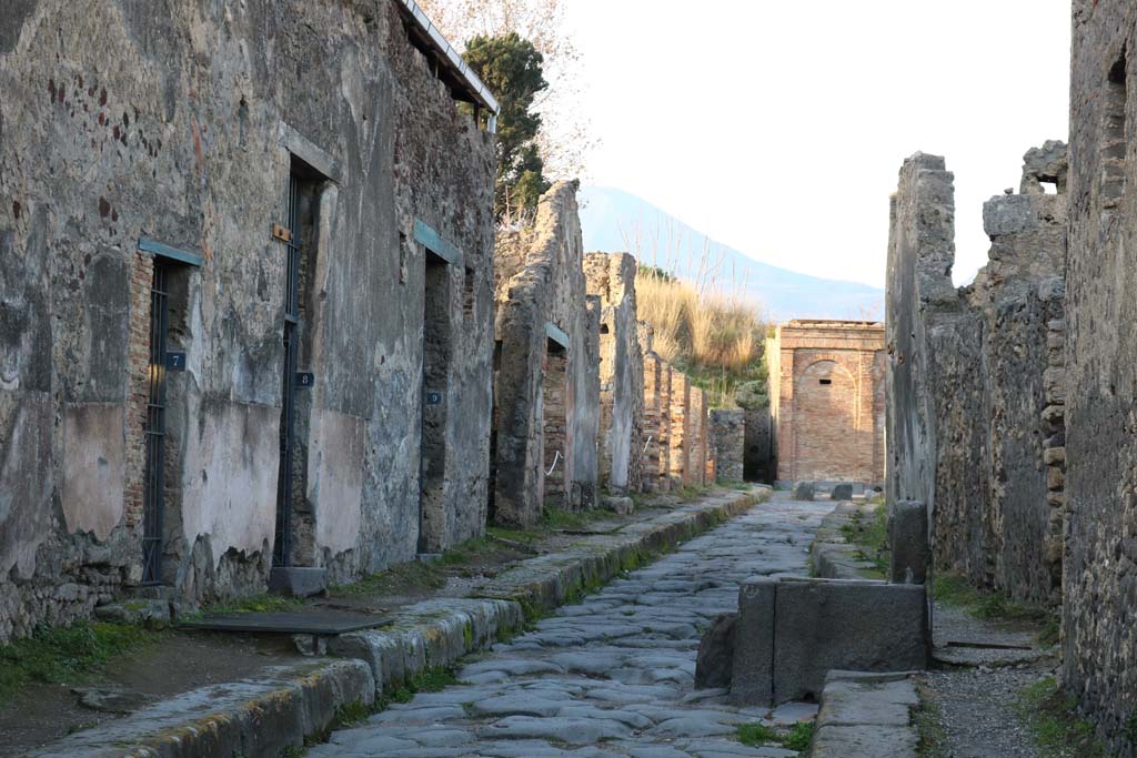 Vicolo dei Vettii, west side, between VI.15 and VI.16. December 2018.
Looking north from VI.15.7, on left, towards VI.15.18, in centre near water tower. Photo courtesy of Aude Durand