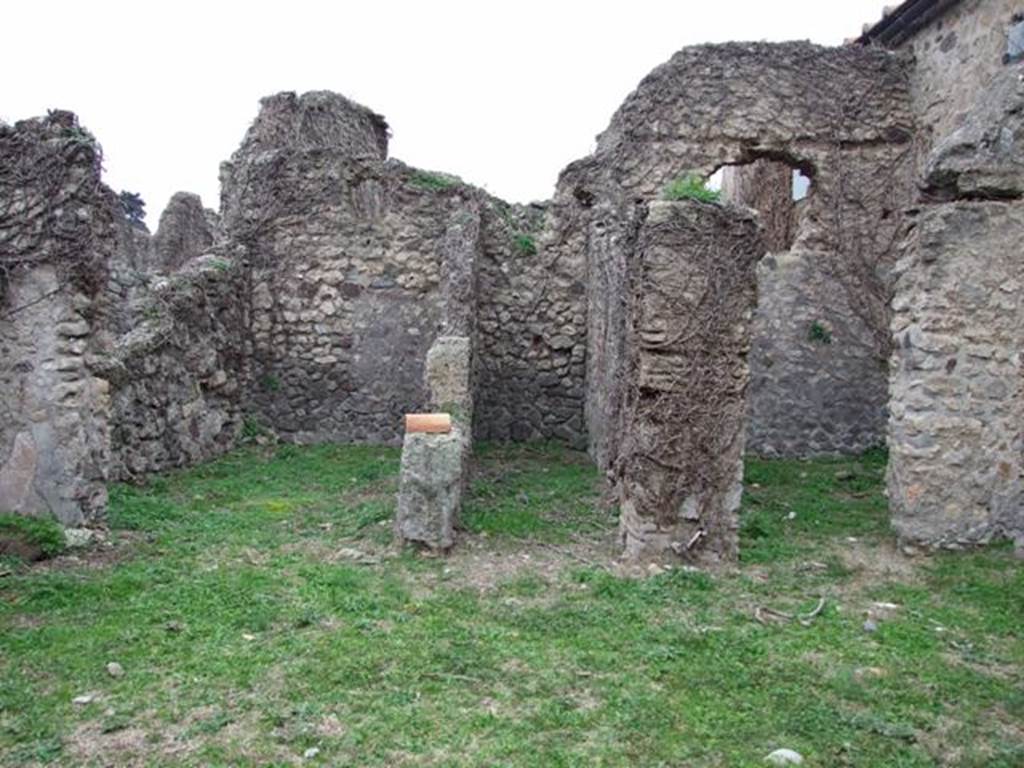 VI.16.13 Pompeii. December 2007. Doorways to three rooms on west side. According to NdS, the room on the left was a small room with opus signinum floor. It was lit by a circular window in the top of the west wall. At the foot of this same west wall, on the floor and also on the sidewalls, one could see the trace left by a very long rectangular form of wooden furniture, that occupied all the lower space from one wall to the other. The room in the centre was a type of small corridor, that received its light from a slit at the top of the west wall. The room on the right had a floor of cocciopesto  and walls faced with rough plaster.
In its western wall was a rectangular window and above it the holes for the beams that supported the upper room. Part of the upper room�s west wall still existed, a continuation of that of the room below, with the remains of the painted decoration, consisting of a panel with a white background, showing the representation of a sea-monster preserved by its serpentine tail, and some small dolphins. See Notizie degli Scavi di Antichit�, 1908, (p.63) 
