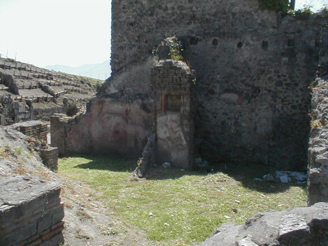 VI.16.20 Pompeii. March 2009. Niche in south wall, originally this may have been in a rear room of VI.16.21/22. According to Boyce, numbered VI.16.20-24.  In the central room on the south side of the house is a rectangular niche. It is in the north side of a pilaster which projects from the east wall (now collapsed). On the wall below the niche, were painted two large yellow serpents on a red background. Not. Scavi, 1908, 182.
See Boyce G. K., 1937. Corpus of the Lararia of Pompeii. Rome: MAAR 14. (p.59, no.225)  
