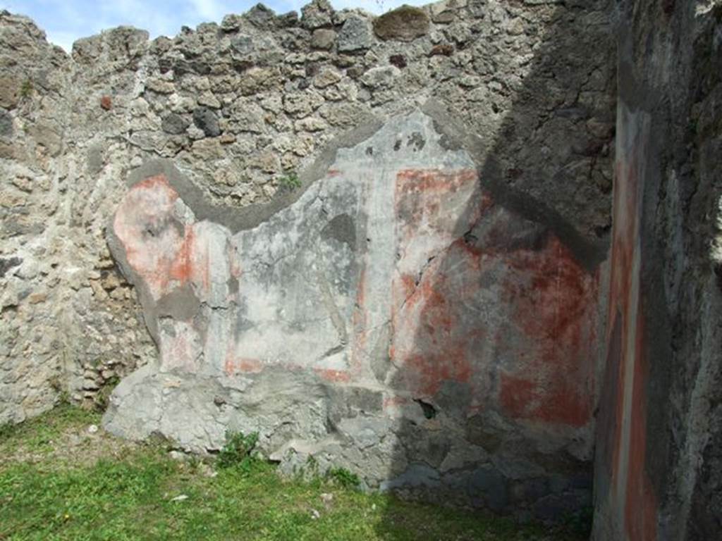 VI.16.32 Pompeii. March 2009. Room E, east wall with central panel (height 1.10m width 0.76m) . According to NdS, the central panel showed a painting of a sacred grove with a herm of Priapus painted in red. On the right was a high pilaster, on top of which was a large rounded vase. Near the base of the pilaster was a red statue of Minerva. To the left of the painting, were two women approaching an altar placed before Priapus, and of these that to the right carried some offerings. In front of the sacred enclosure was either a river or lake, with a bridge. At the left end of the bridge were two goats drinking. There was also another woman followed by a boy and a girl. See Notizie degli Scavi di Antichità, 1908, (p296-7).