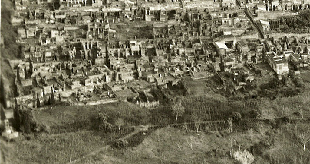 VI.17. 1 � 28, Insula Occidentalis, dated 9th January 1954, detail from RAF Aerial photo. Photo courtesy of Rick Bauer.
Starting from the right, the white reconstructed dwelling would be VI.17.27/8, House of the Skeletons, opposite the Vicolo di Mercurio.
On its left would be VI.17.25/26, opposite the House of Sallust, and next to that, on its left, would be the street level peristyle of VI.17.23, with a view of the remaining floors beneath, all part of the House of the Lion.
On its left, divided by a wall, front to back, would be VI.17.17/16, the House of C. Ceio.
On its left, another dividing wall would separate VI.17.13, the House of C. Nivillio
On its left would be VI.17.10/9, with some of the rear remaining floors underneath no.10, the House of the Danzatrice/of House of Diana I, opposite the House of the Surgeon.
Then there is the small house at VI.17.5, the House of Popidius Rufus
On the left of the photo is the rear of the area from VI.17.1/2/3/4. 
