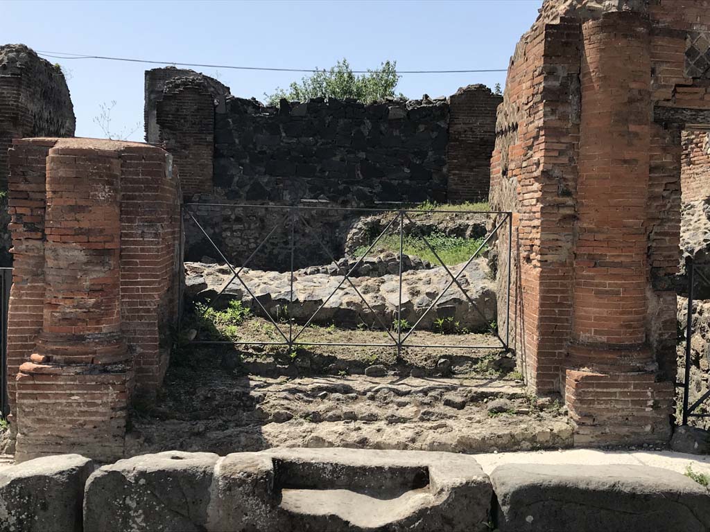 VI.17.36 Pompeii. April 2019. Looking west past step cut in kerb to entrance doorway with a brick half round column on each side.
Photo courtesy of Rick Bauer.
According to Breton –
“This house was built on the ancient city ramparts and had many floors on terraces leading down to the sea, it appears to have been very large but despite the excavations made in 1808 and 1817, it had never been fully excavated. Of the remains, much of it was in a large state of degradation.
This house showed many remarkable peculiarities, having two doors onto the same street opening directly and without a prothyron onto two rooms bigger than an ordinary vestibule. The large Corinthian atrium did not have a width of less than 28.9m: its portico was formed of arches and columns.
The portico of the atrium, as well as several rooms, was paved with black and white mosaics.
A fountain that decorated this area was not placed in the axis of the atrium, but a little to the side, in order to face the door of main vestibule.
In one of the rooms that surrounded the atrium was another small fountain. Under this house was the most beautiful cellar yet found at Pompeii.
See Breton, Ernest. (1855). Pompeia, decrite et dessine: 2nd ed. Paris: Baudry, (p.219-220)