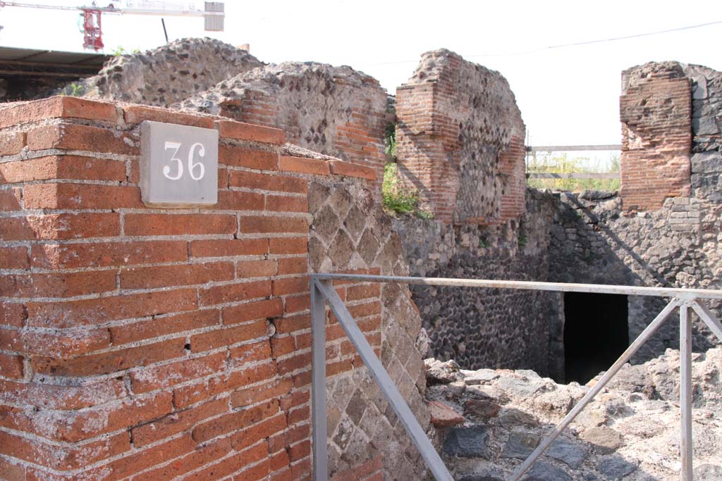 VI.17.36 Pompeii. September 2021.
Looking south-west from entrance doorway up steps to the atrium level, with doorways to rooms on south and west side.
On the right is a doorway in a lower level. Photo courtesy of Klaus Heese.