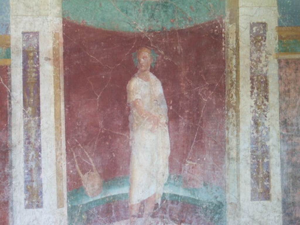 VI.17.41 Pompeii. May 2006.
East wall of exedra 18 on north side of cubiculum 17. Detail of painting of robed figure with instruments, set in an apse on east wall.