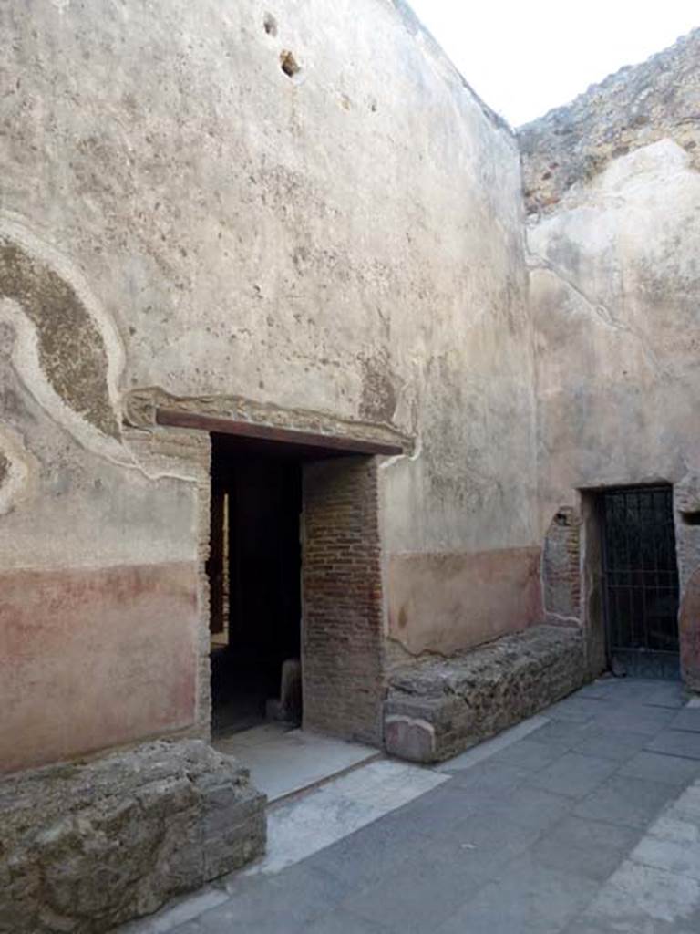 VII.1.14 Pompeii. June 2012. Looking north-west across waiting room 2a of Stabian baths. The doorway in the centre leads into the men�s changing room 2. The gated doorway, on the right, would lead towards VII.1.15. Photo courtesy of Michael Binns.