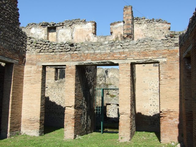 VII.2.18 Pompeii.  March 2009. Room 9, upper floor apartment, latrine in north wall of upper floor. According to Hobson, a total of 15 upper storey latrines have been identified in the city, including this one. He says that these latrines would seem to have been placed near to the top of the staircase, and would have been placed in narrow plastered niches with terracotta downpipes inserted into the walls to carry the waste product down into the cesspit.  This latrine shows the slots in the sides of the niche where the wooden seat fitted, and the tapering, easily sluiced plaster below the seat.
See Hobson, B., 2009. Latrinae et foricae: Toilets in the Roman World. London; Duckworth. (p.75-6).

