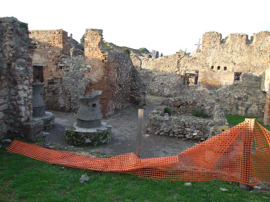 VII.2.22 from VII.2.23. December 2006. Looking north from area of triclinium across the site of the bakery at VII.2.22.