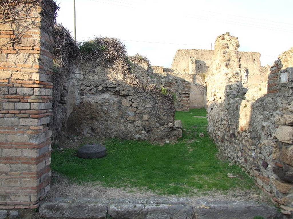 VII.2.37 Pompeii. May 2005. North-east corner of shop, with doorway into atrium of VII.2.38.