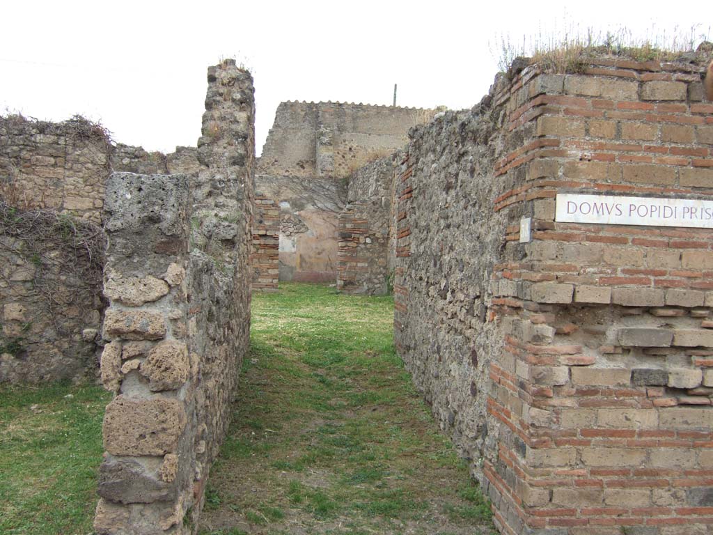 VII.2.38 Pompeii. May 2006.  Looking north across atrium towards passageway to small room, possibly kitchen (on left). On the right, would have been the tablinum with window.
