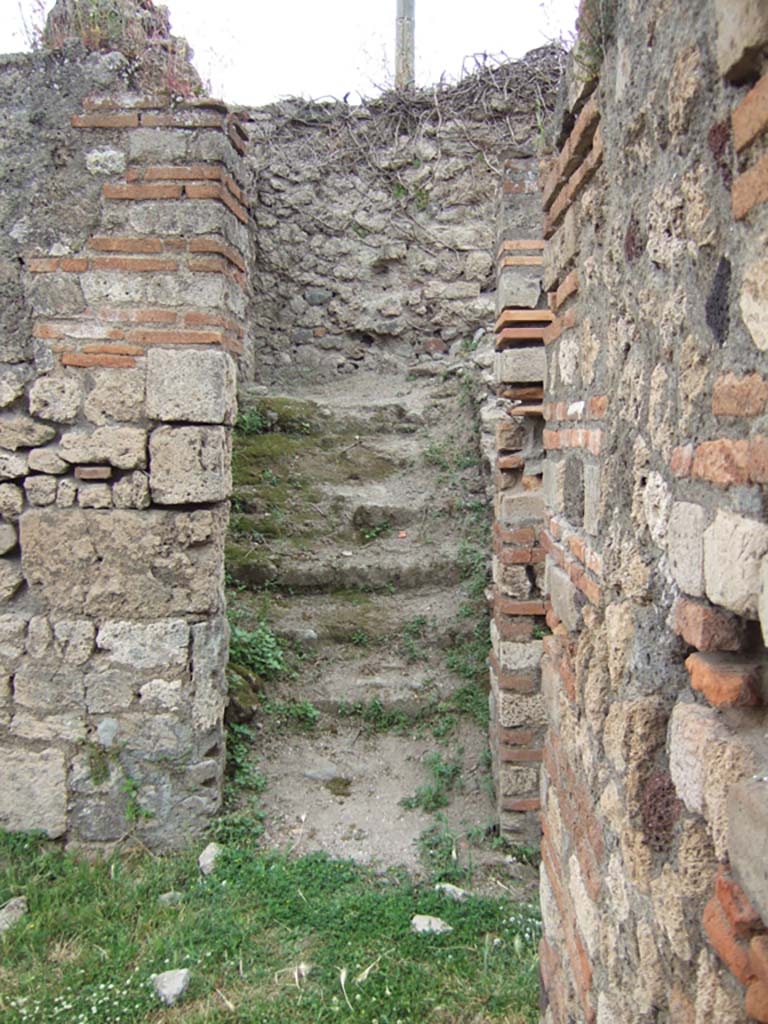 VII.2.38 Pompeii. May 2006. West side of atrium, doorway to rear cubicula (on left), and doorway to stairs (on right).