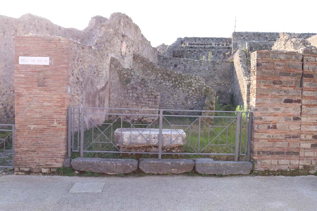 VII.3.23 Pompeii. March 2009. Wall south of VII.3.22, with terracotta and tufa plaque.