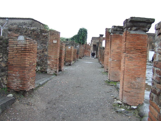 VII.4.3 Pompeii. December 2005. Looking east from entrance. The steps to the upper floor can be seen in the south-east corner of the shop-room, on the right. The doorway to the rear room can be seen in the north-east corner, on the left.  In the rear room, against the east wall, there is a block of tufa stone, found on this was CIL IV 6602.  This block of stone can partly be seen through the doorway. The graffito read -
 M(arcum)  Artor(ium)  II v(irum)  [...]    [CIL IV 6602]
See Varone, A. and Stefani, G., 2009. Titulorum Pictorum Pompeianorum, Rome: L’erma di Bretschneider, (p.355 & photo XXVb)
Eschebach thought it may have been used as a podium ?
See Eschebach, L., 1993. Gebäudeverzeichnis und Stadtplan der antiken Stadt Pompeji. Köln: Böhlau. (p.272)



