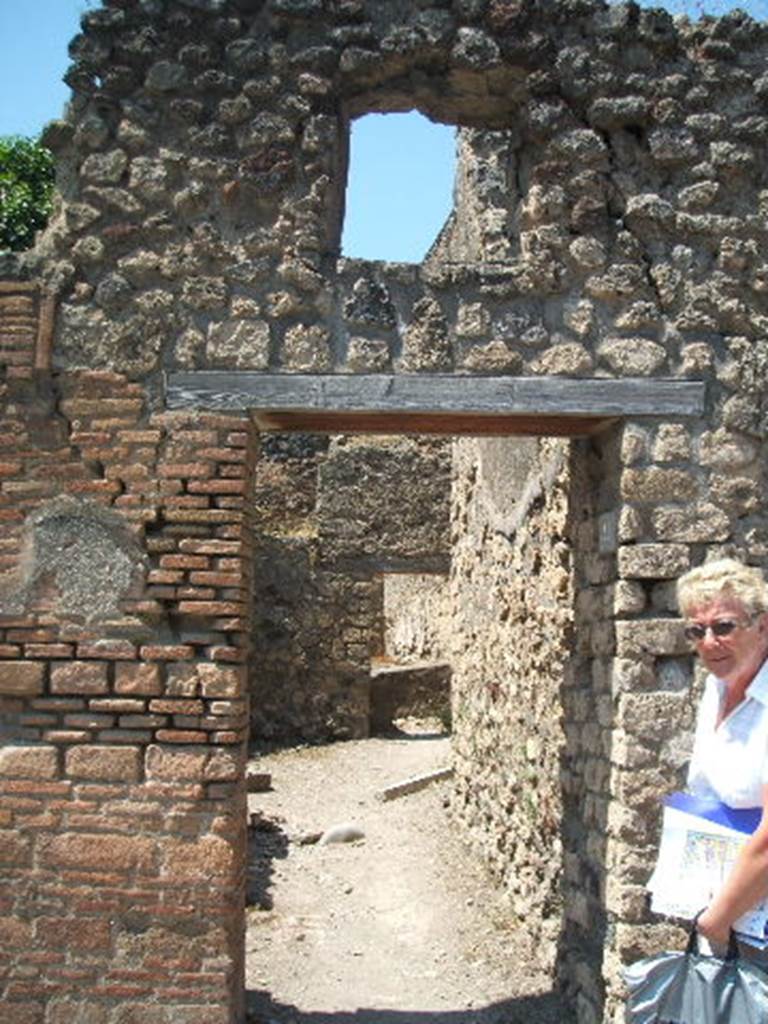 VII.4.41 Pompeii. May 2010. Latrine on south side of entrance. The steps to the upper floor would have been above this latrine.