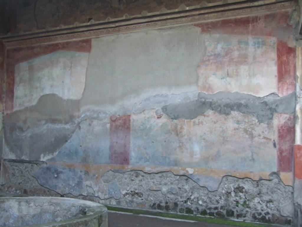VII.4.48 Pompeii. December 2007. Peristyle, west wall. Due to the explosion of a bomb which fell in 1943, the west wall suffered from the destruction and the partial fall of the plaster from the large painting. The figure of Galatea in the centre of the lower zone was definitely destroyed.
See Garcia y Garcia, L., 2006. Danni di guerra a Pompei. Rome: L’Erma di Bretschneider. (p.98, fig 218)