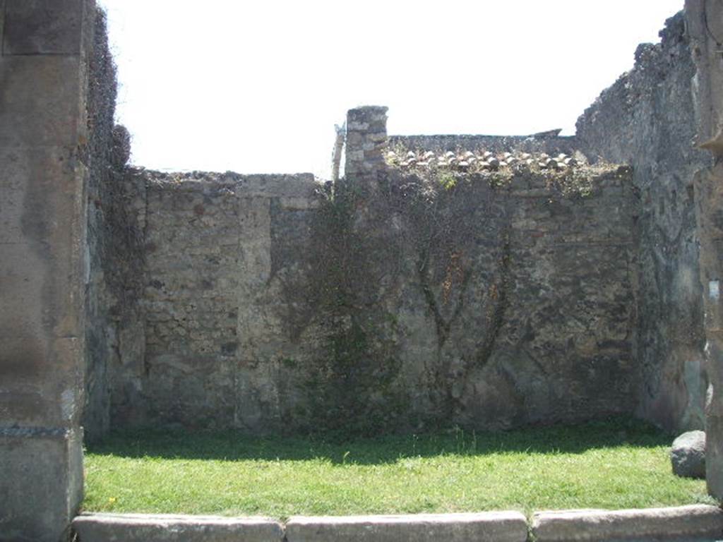 VII.4.49 Pompeii. May 2010. South wall with a bricked-up doorway to a rear room in the south-west corner.